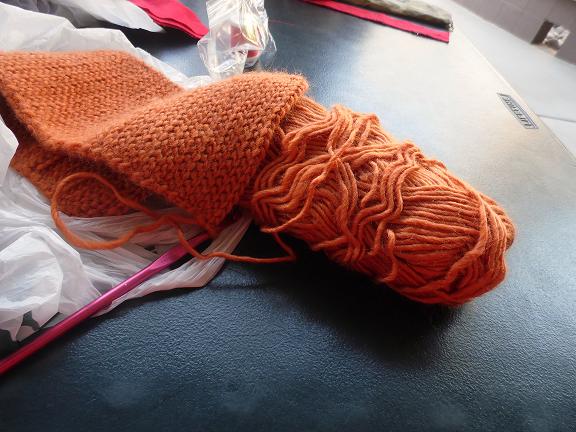 Orange yarn complete with a hook. Crocheting and other fiber arts are for all ages to enjoy and benefit from.