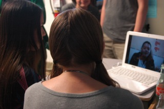 Spanish students crowding around the computer to Skype with the students of the Howard Gardner American School in Guatemala. 