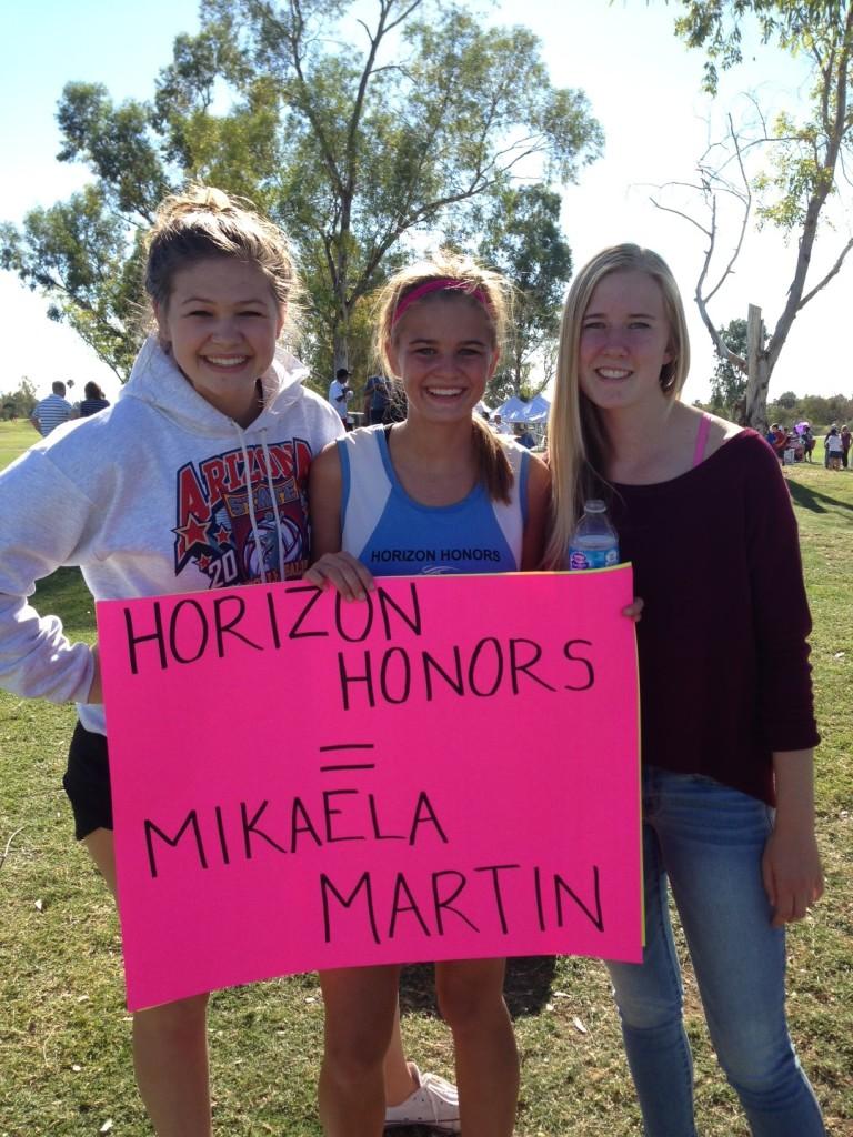 Senior Mikaela Martin (center) with sister Emma Martin (left) and friend Hannah Wikoff (right). This was after Martin had finished running. 