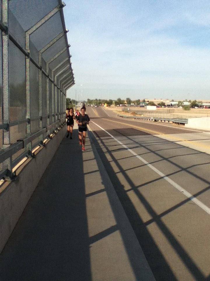 Runners, Kenzie Knippers and Alexis VandeMore, run to Pecos Park for a warm-up.
The team ran a total of 4 miles that practice.
Photo Courtesy of Erica Kendree, © 2013.