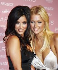 Kim Kardashian and Paris Hilton posing together at a red carpet event. Photo Courtesy of Brian Warner © 2012