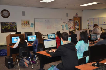 Journalism students pull up the homescreen for their favorite social media site during class. pose for a picture of their computer screens. Only one students picked Facebook.