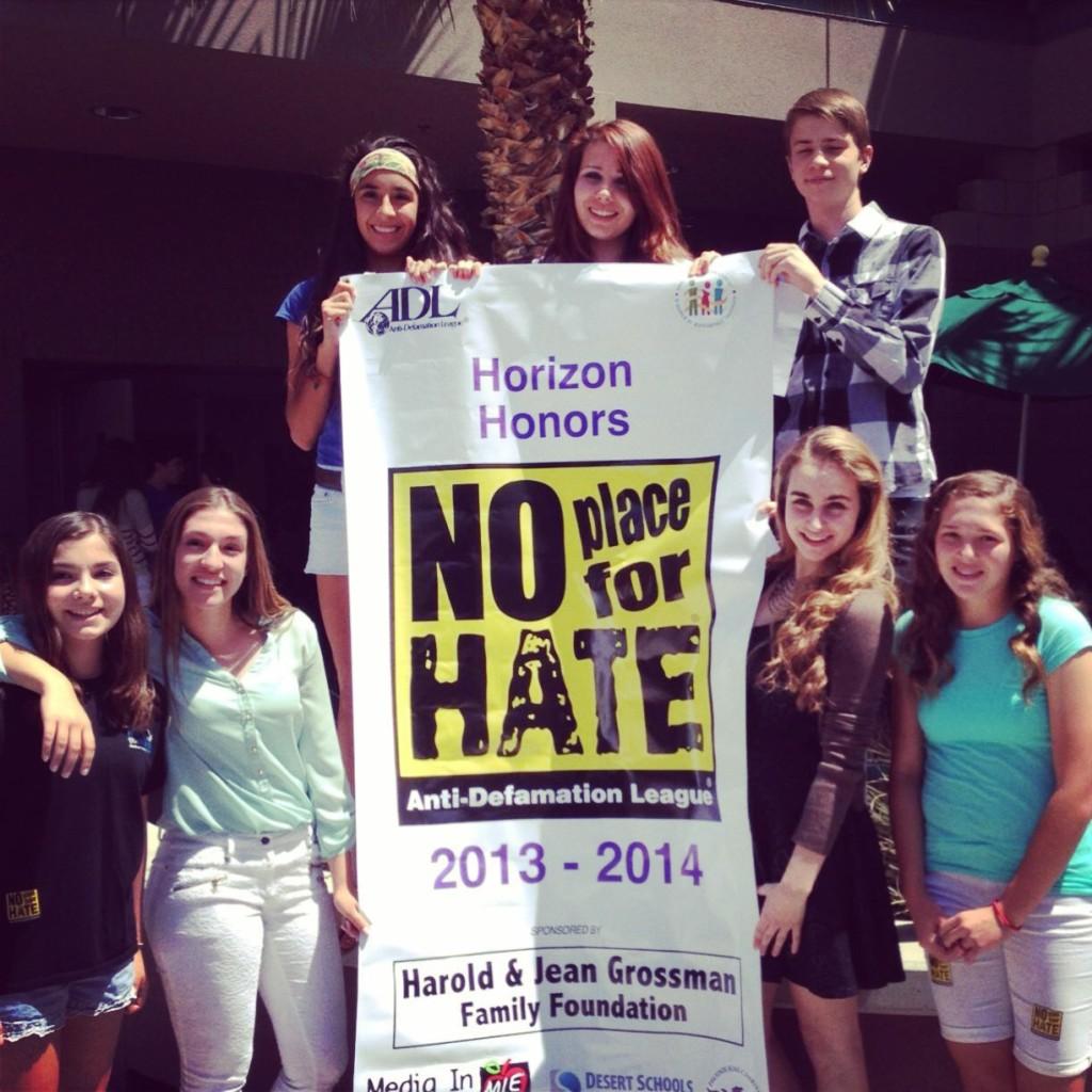 (L to R) Seventh grader Tessa Jung, freshmen Karolina Grgurovic, Krista Santacruz, sophomores Kori Klein, Wesley Jamison, junior Alexa Geidel, and seventh grader Finley Lindsey pose with the official No Place For Hate banner.  It declared Horizon Honors as a member of the national organization and the first charter school in Arizona to receive the recognition. 