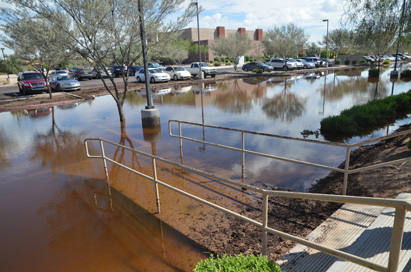 The church parking lot was transformed into a wasteland of debris and erosive runoff. Monday’s great flood spawned some marshes around the school that are still yet to dry.
