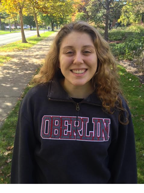 College freshman, Madeline Moran, cheesing on campus in her favorite Oberlin sweatshirt.
