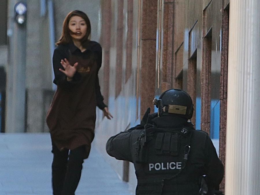One of the hostages who fled the scene before police cleared it up in Sydney, Australia. About 30 people were held hostage for around 16 hours, through the night of December 14.