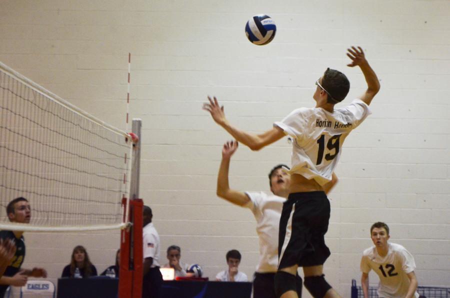 Sophomore Trevor Weary jumps to spike the ball to the other side of the court.