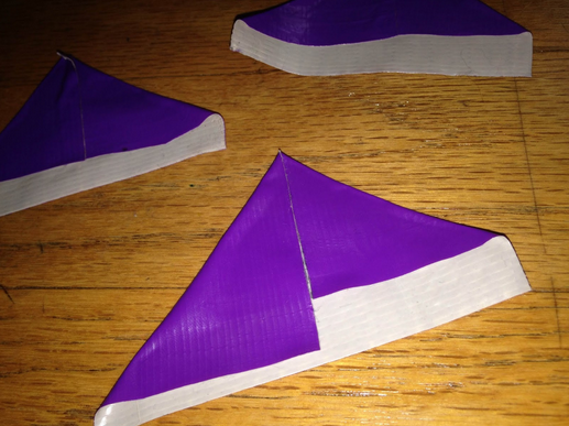 Take the pieces you just cut out and fold the top corners inward so the edges touch, creating a triangle-like shape.