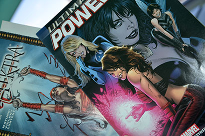 Ultimate Power and Elektra comic books both feature women on the cover.