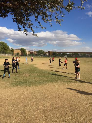 The people who are trying out for softball get ready by warming up.