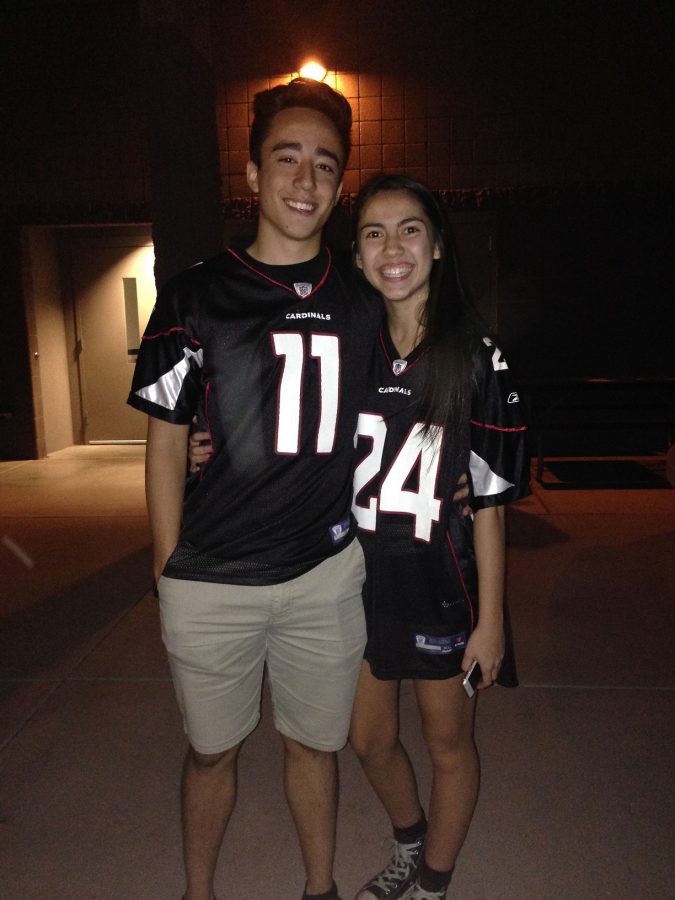 Seniors Tiana Oster and Aaron Tam pose for a picture in matching Cardinals jerseys.