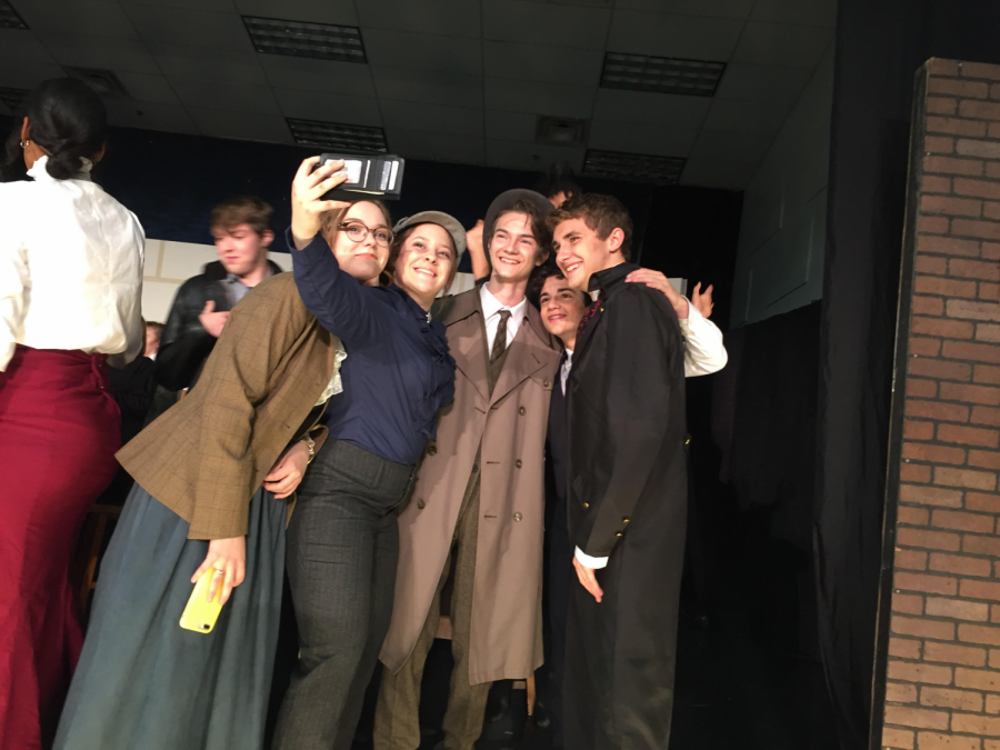 Sherlock Holmes (junior Jocey Price) takes a selfie with her castmates.