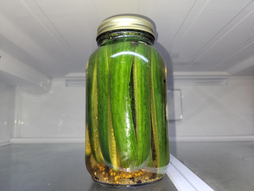 Fermenting cucumbers in a jar causes them to become pickles.