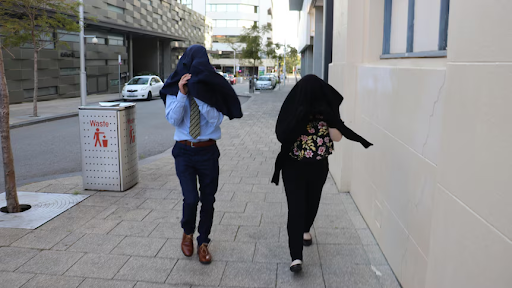 The unidentified parent’s to the victim, covering their faces to avoid the media as they go in and out of court.