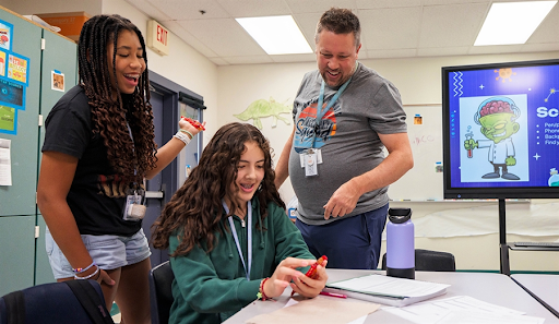 Students with teachers in the science classroom.