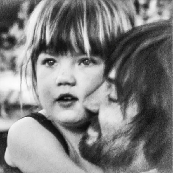 Monochromatic picture of Kevin Parker (Tame Impala) holding his daughter, Peach Parker